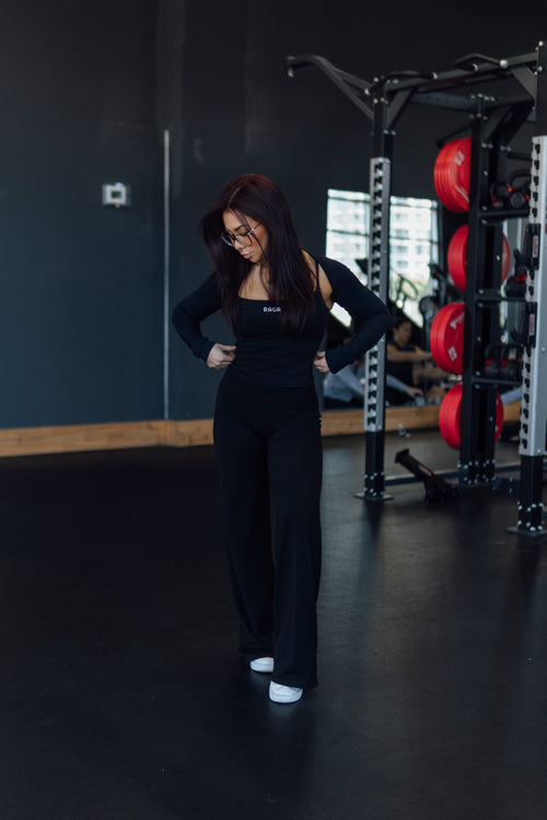 Black flared workout leggings for women featuring contouring fabric, four-way stretch, and a flattering silhouette for training and lifestyle.