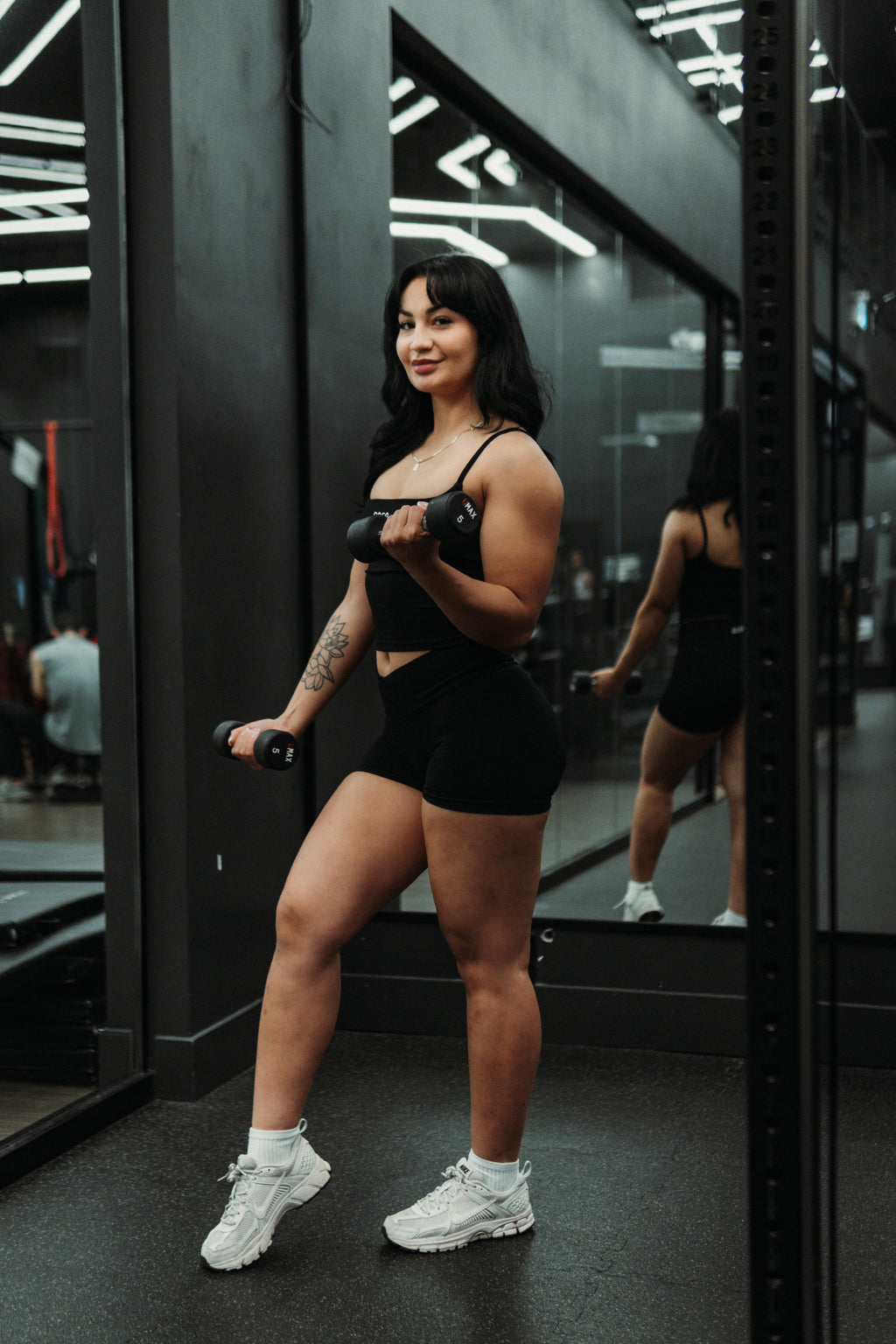 RAGA black seamless tank top paired with black V-waist Effort seamless shorts.
