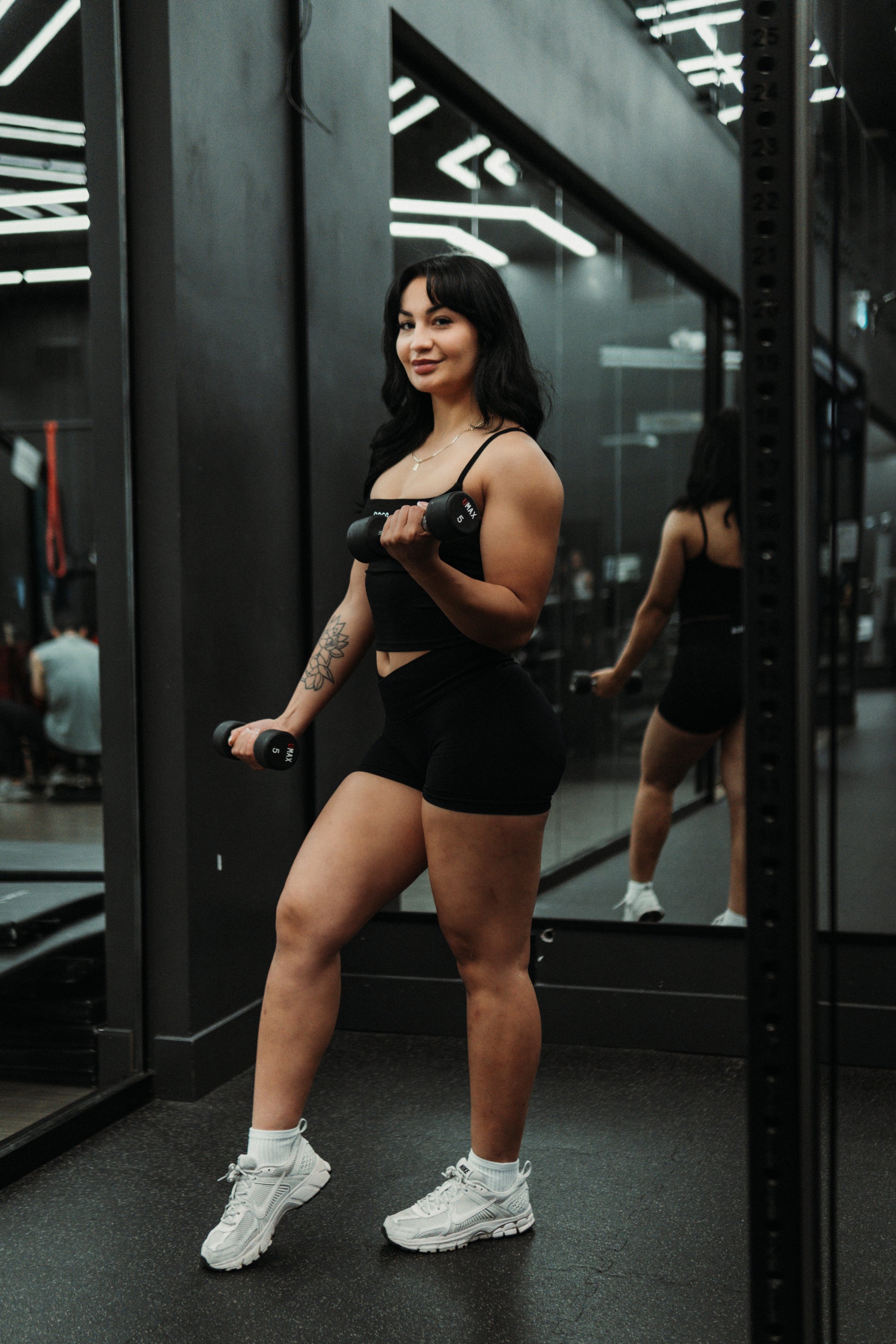 RAGA black seamless tank top paired with black V-waist Effort seamless shorts.
