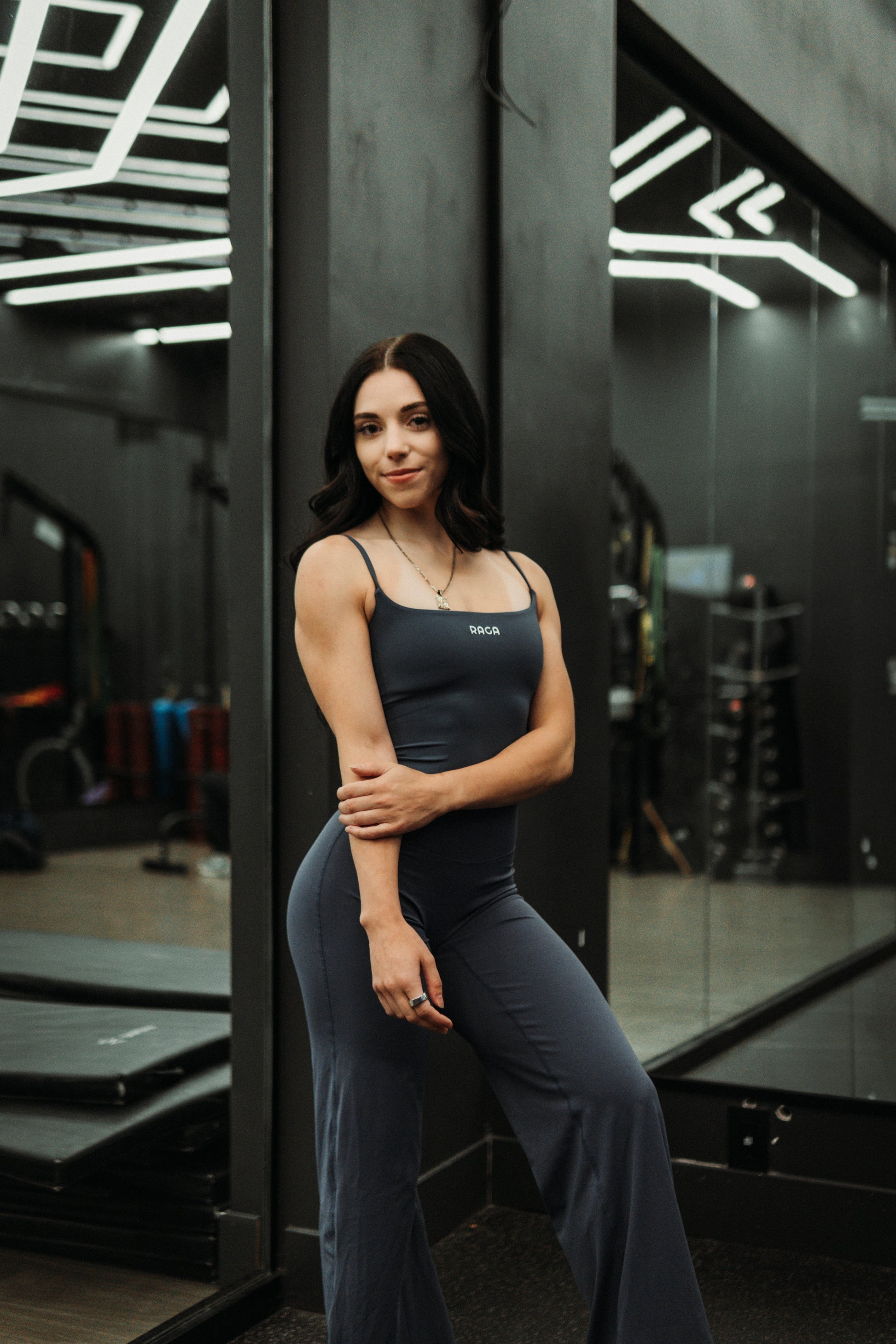 Women's blue grey flare gym pants with a body-hugging fit through the hips and thighs, finished with a sleek flared leg for a balanced silhouette.