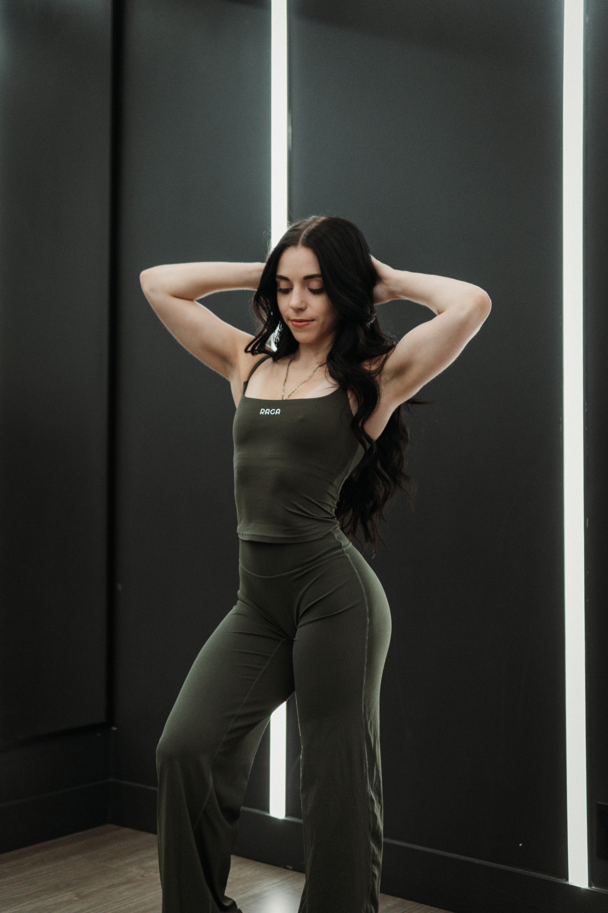 Olive green RAGA flared workout leggings for women featuring a body-hugging fit through the hips and thighs with a comfortable flared leg.